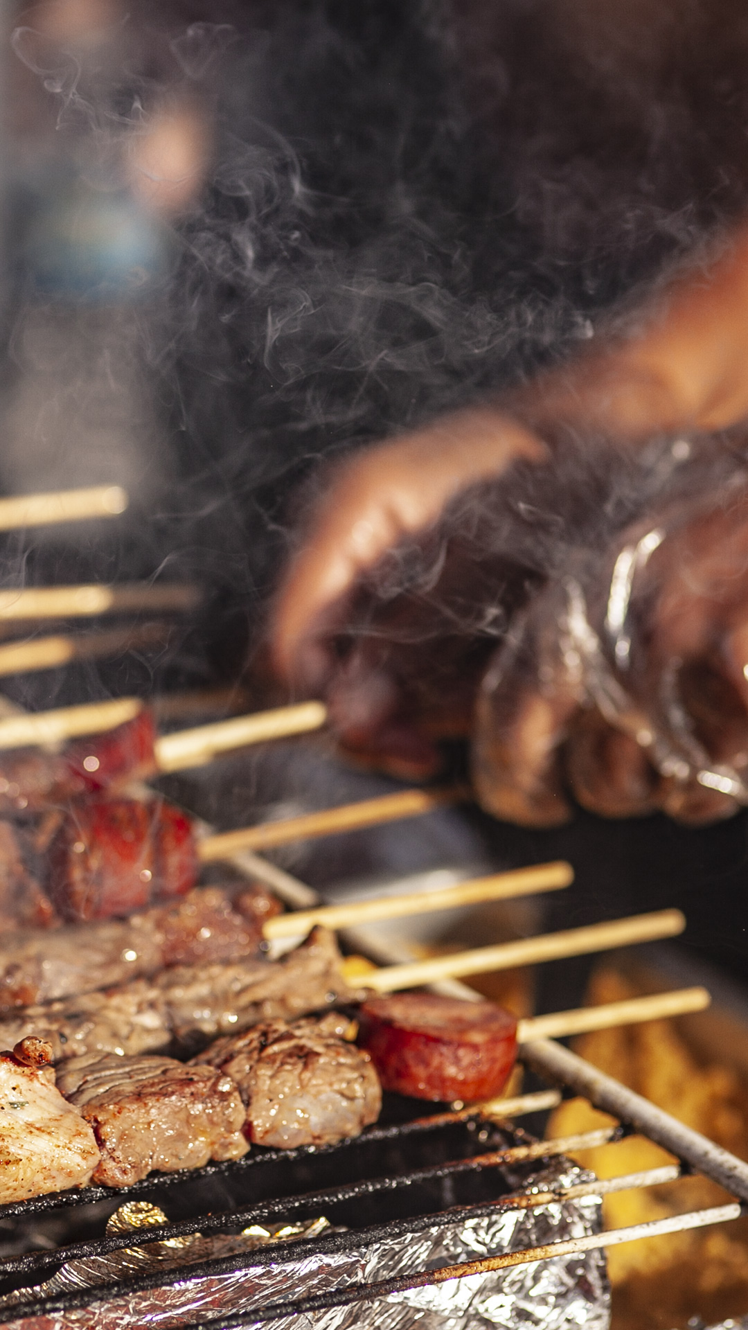 Delicious aromas fill the air as street food vendors prepare mouthwatering snacks for hungry partygoers.